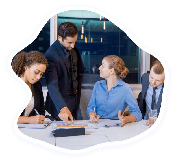 Colleagues reviewing project documents around a meeting table